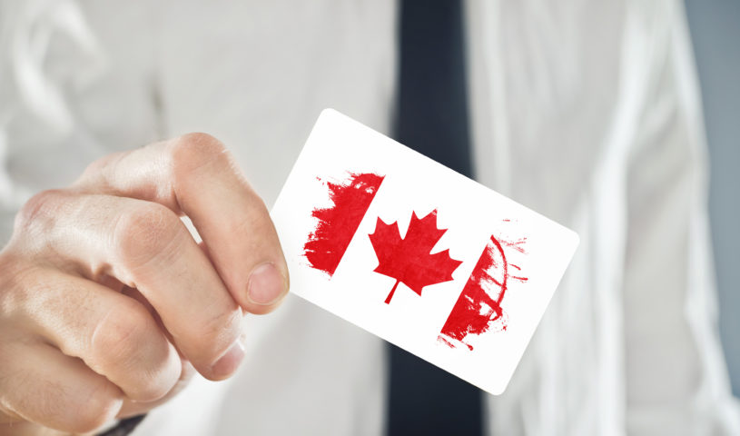Canadian Businessman holding business card with Canada Flag