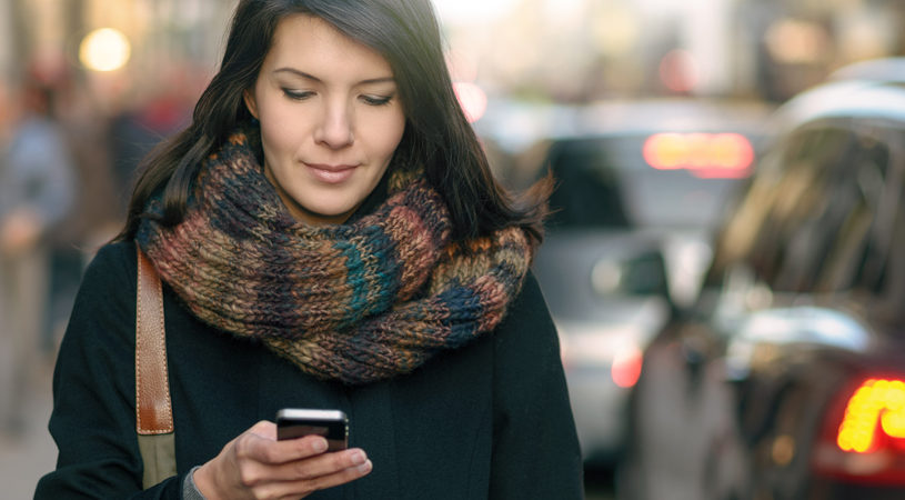 Fashionable Woman Busy with Phone at City Street