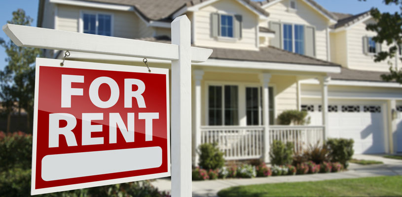 Right Facing Red For Rent Real Estate Sign in Front of Beautiful House.